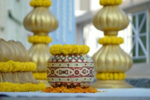 Traditional Indian decorations at a Haldi ceremony featuring marigold flowers and ornate pots.